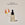 A clear glass bottle with a dropper containing the Brightening Glow Serum, labeled with the brand ACURE next to a circle displaying old packaging and text calling out: New look , same proven formula